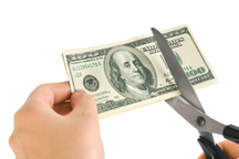 Hands with scissors cutting money