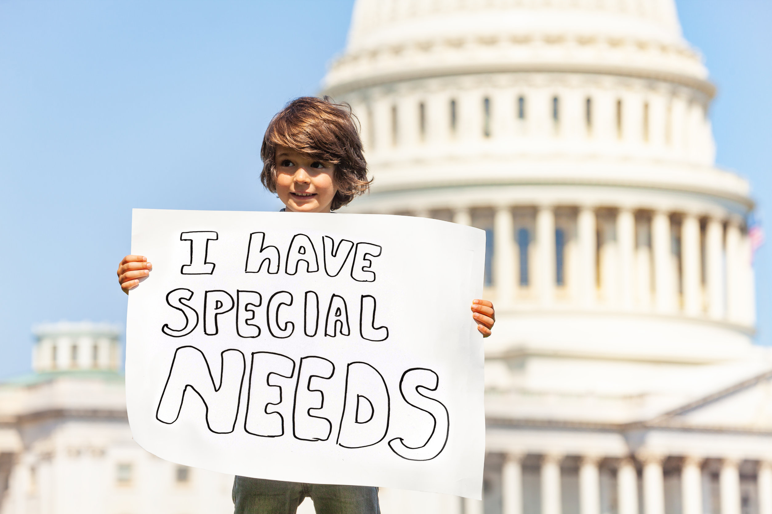 Protester boy holding sign I have special needs