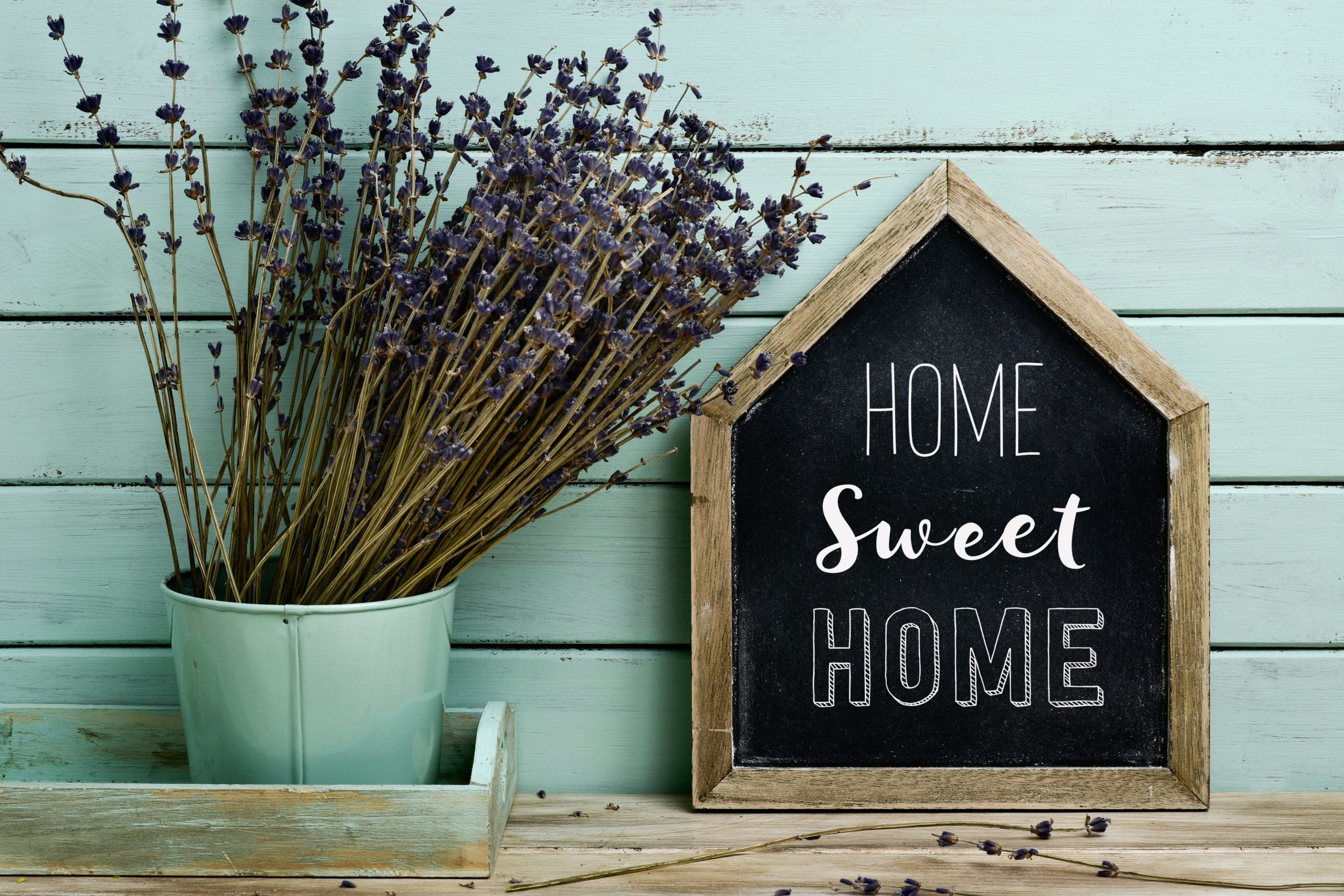text home sweet home in a house-shaped signboard