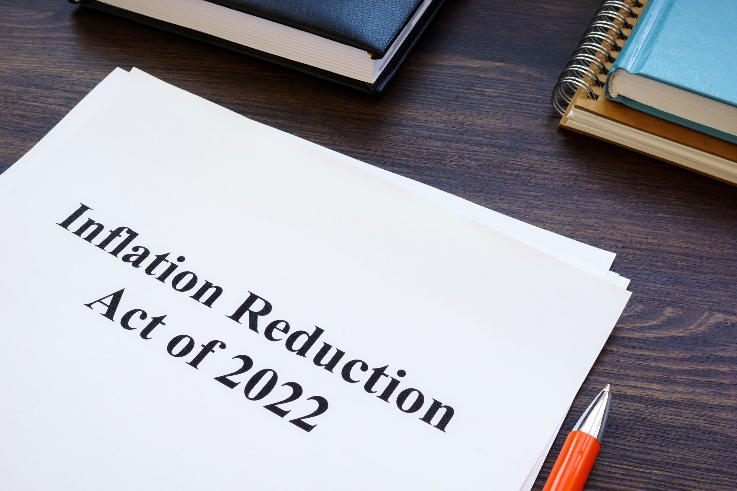 Papers with Inflation Reduction Act of 2022 and notepad.